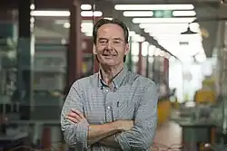 Photograph of Currie standing outside a laboratory