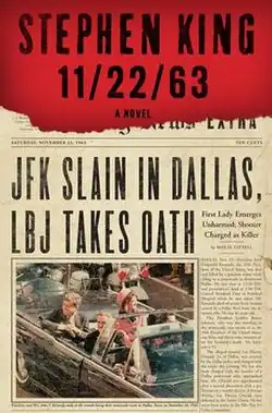 Against a red background, the author’s name appears prominently near the top of the book cover in red, with the book title below it in black. The cover is dominated by an illustration of the front page of a vintage newspaper. A headline reads, "JFK SLAIN IN DALLAS, LBJ TAKES OATH", and a subtitle reads, "First Lady Emerges Unharmed; Shooter Charged as Killer." A photograph below the headline shows a motorcade which includes the presidential limousine