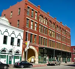 A large red-brick building with an archway at the entrance