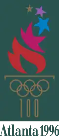 A fire, emitting many different-colored stars, burns from a cauldron represented by the gold-colored Olympic rings and the number "100" acting as the cauldron's stand. The words "Atlanta 1996", also written in gold, are placed underneath. The image is situated on a dark green background, with a gold border.
