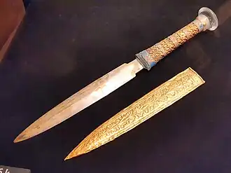 Replica of the iron-bladed dagger, placed near the right hip