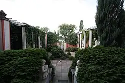 The back garden of Rożek's villa (currently, the Marcin Rożek Museum) leading to Lake Wolsztyn at 34, 5 Stycznia Street in Wolsztyn, lined with numerous busts and sculptures created by Rożek