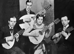 Four people, three men and one woman, all holding lutes