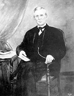 A black and white photo of a painting of Alfred Beckley, a man wearing a suit and sitting in a chair