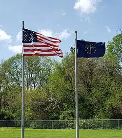 The Indiana flag flying beside the American flag.