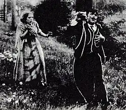 A black and white photo of a young woman encountering a fatally injured peddler