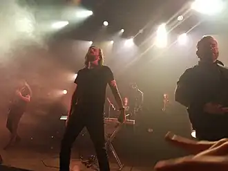 Between the Buried and Me performing in August 2018 L–R: Paul Waggoner, Tommy Giles Rogers Jr., Blake Richardson, Dan Briggs, Dustie Waring