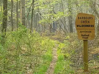 Photo of a sign at the entrance to Barbours Creek Wilderness along a hiking trail