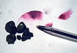 Crystals of fuchsine dye and the color they produce