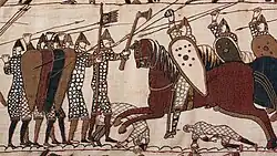A scene from the Bayeux Tapestry depicting mounted knights attacking footsoldiers