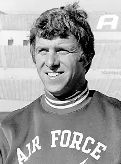 Bill Parcells smiling in an air force shirt, shown from about the chest up.