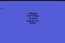 A plain, blue screen with small, pixelated black letters in the center: Happy Birthday to you Robert A. Tokar