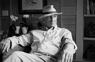 Bob McDill sitting in a chair wearing a hat