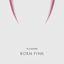 Cover artwork of Born Pink – a pair of pink fangs are displayed on top against a white background. Below are text reading "BLɅϽKPIИK" and "BORN PINK".