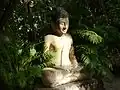 Khmer mediation Buddha in the garden of Silver Pagoda .