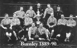 A black and white image of the Burnley team with the Lancashire Cup trophy in the middle