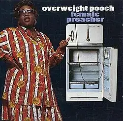 The cover features Pooch wearing a red-and-white striped attire with yellow flower designs and sunglasses, standing next to an open refrigerator with a microphone hanging over it. Both the artist's name and album title appear above the refrigerator, colored in white and cornflower blue respectively.