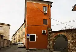 Row of old houses with a small stone turret visible among them.