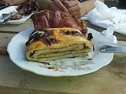 A roll of cooked potato dough known as chochoca, with crispy smoked pork