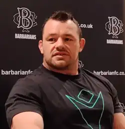 Cian Healy, seated, at a press conference before a Barbarian F.C. match