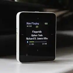 An image of a ZEN Style M100 in White showing the Now Playing screen