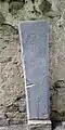 Graveslab of Nicholas Baron, abbot until 1532, using an earlier, 13th century gravestone