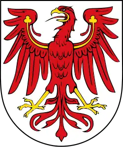 Argent, an eagle displayed gules armed and wings charged with trefoils Or. Arms of Brandenburg.