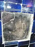 An etched figure of a giant hand in the complex, showing Twelver Shi'a sign of Panj-tan-e Āl-e Abā