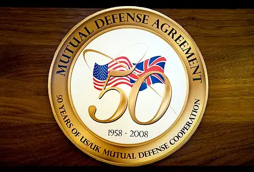 The logo contains the flags of the two countries overlaid with a stylised gold "50"