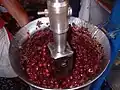 Mincing açaí berries into a pulp