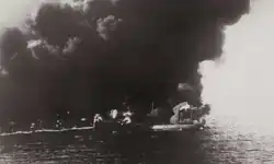 Dixie Arrow burning, thick smoke surrounding her