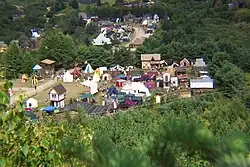 A small town constructed in a medieval style, surrounded by forest
