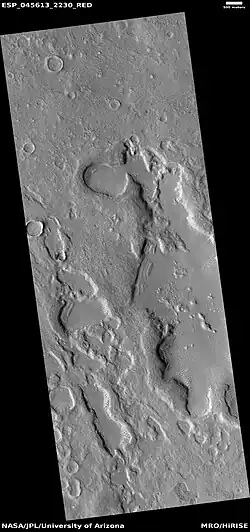Wide view of dipping layers along mesa walls, as seen by HiRISE under HiWish program Location is Ismenius Lacus quadrangle.