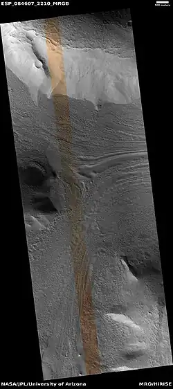 Lineated valley fill in valley, as seen by HiRISE under HiWish program. Linear valley flow is ice covered by debris. Lineated valley fill is generally considered to be and example of a glacier, as it involves the movement of ice.