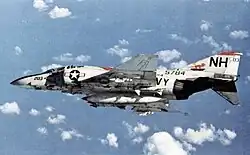 White F-4 Phantom of the US Navy banking away from the camera
