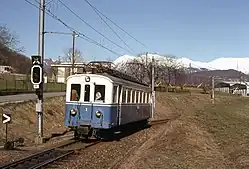 Blue and white single-carriage electric train