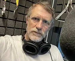 An image illustrating the audiobook narrator Matthew Lloyd Davis in his workspace