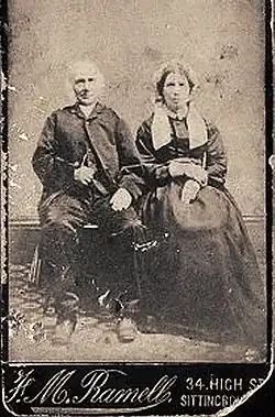 Nineteenth-century British couple. The lady is wearing lappets hanging down on each side of her neck.