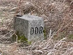 An East German boundary stone with the letters "DDR" (Deutsche Demokratische Republik) carved on the western-facing edge