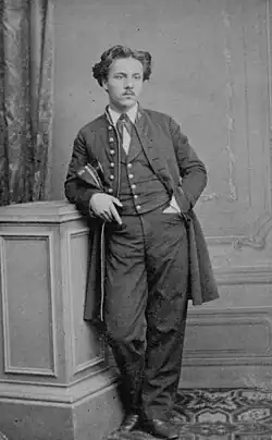 young man in elaborate scholastic uniform with frock coat