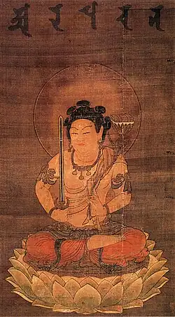 A japanese painting of Manjushri (monju) holding a sword and a lotus topped with a sutra, Kamakura period