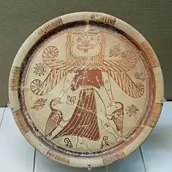 Fig. 3. Winged Gorgon with volute nose, wide mouth, tusks/fangs, tongue, and beard, as Mistress of Animals flanked by geese; plate from Kameiros, Rhodes, British Museum A 748 (late seventh century BC)[69]
