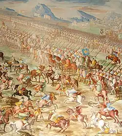 A painting of a battle with a long line of mounted riders side by side in front of a line of marching men. In front of the riders are a number of individual horsemen fighting.