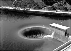 Bell-mouth spillway of Hungry Horse Dam in operation