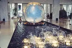 A photograph of the interior of Explorers Hall in the Stone Building, depicting a large sphere set in a black granite reflecting pool