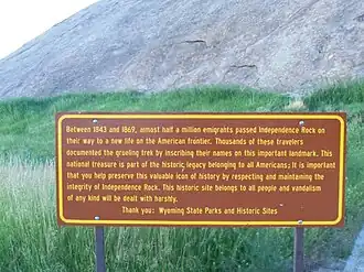 A sign in front of Independence Rock describing the history of the site, taken in 2011.