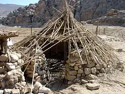 Reconstruction of an early PPNB semi-buried round house in Beidha, Jordan.