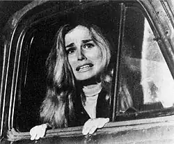 Judy peers from an open truck window.