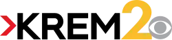 A red arrow next to the black letters K R E M in a sans serif, with a large yellow 2 to the right and the CBS eye in gray in the lower right corner