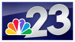 The NBC peacock in the lower left next to a silver slightly angled number 23 sitting over a glossy, navy blue box.